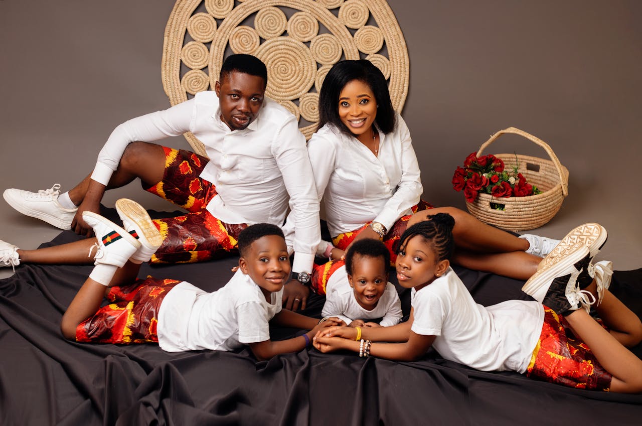 The Art of Drawing Readers In: Your attractive post title goes here A joyful family of five in matching outfits posing happily together indoors.