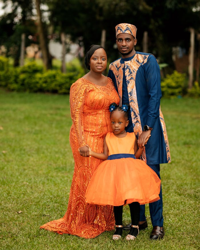 Mastering the First Impression: Your intriguing post title goes here Family portrait with vibrant traditional African attire in a lush garden setting.